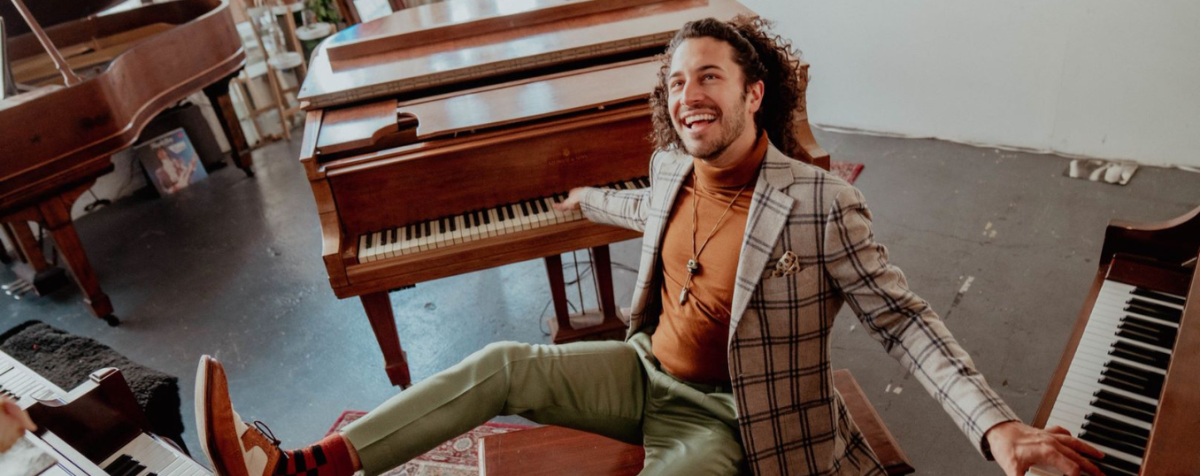 Emmet Cohen seated at piano