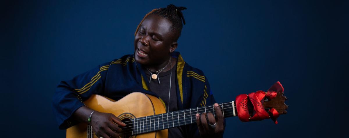 Okaidja Afroso playing guitar